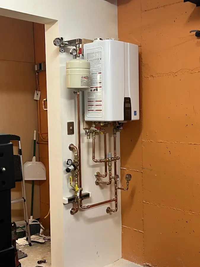 Plumbing technician inspecting water heater connections in Issaquah